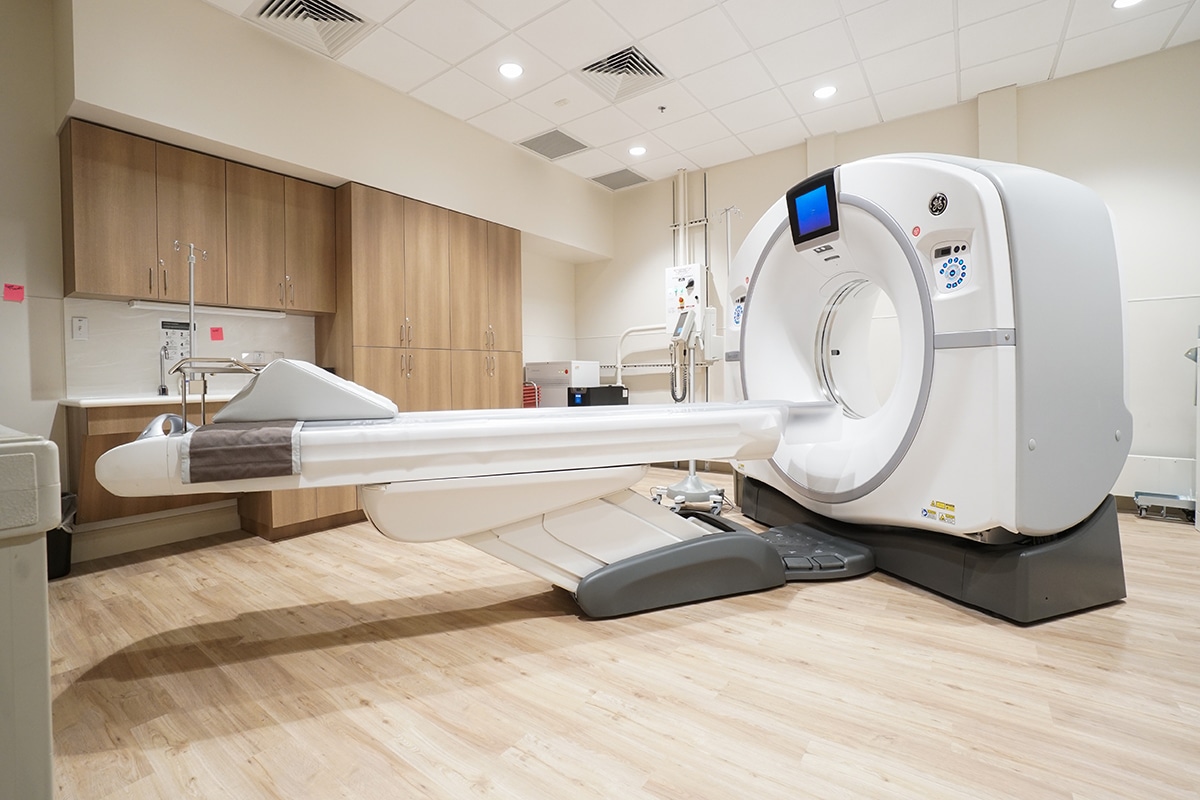 A CT scan machine in a room with cabinets