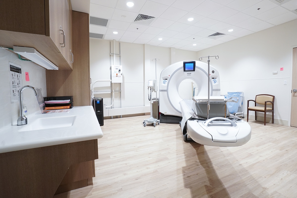Flooring of CT scan room at Bethesda Health City with a CT scan machine and a wall sink.